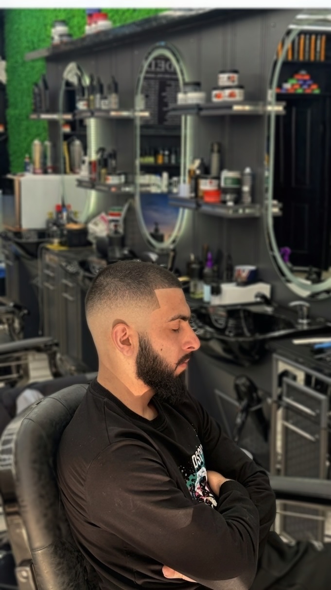 Skin fade with sharp line-up and full beard shaping