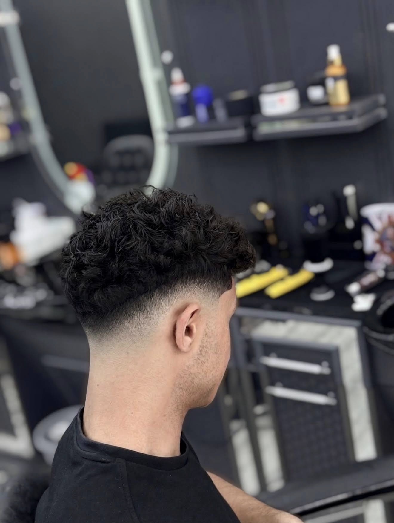 Curly top with drop fade and clean neckline