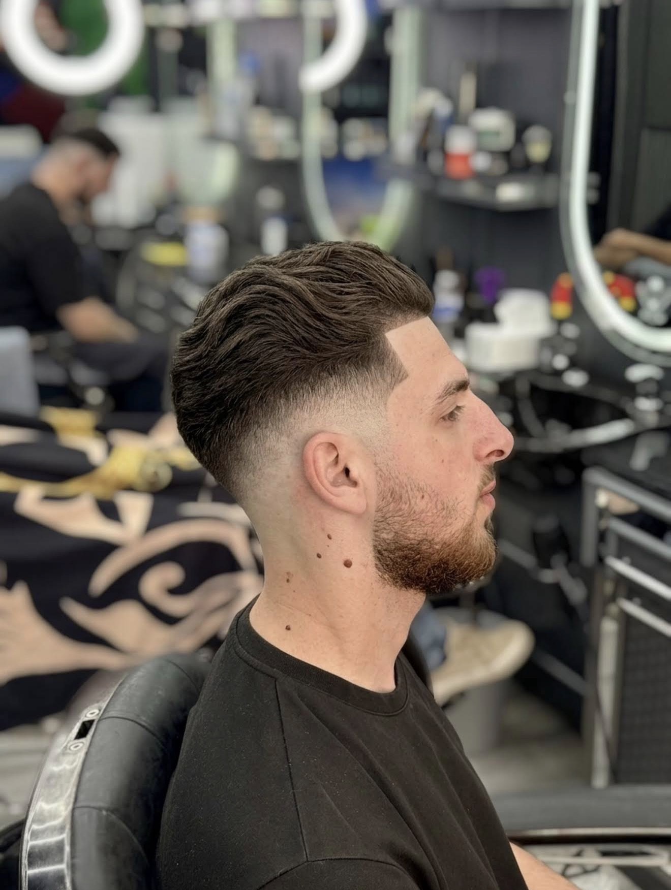 Textured quiff with mid skin fade and beard trim